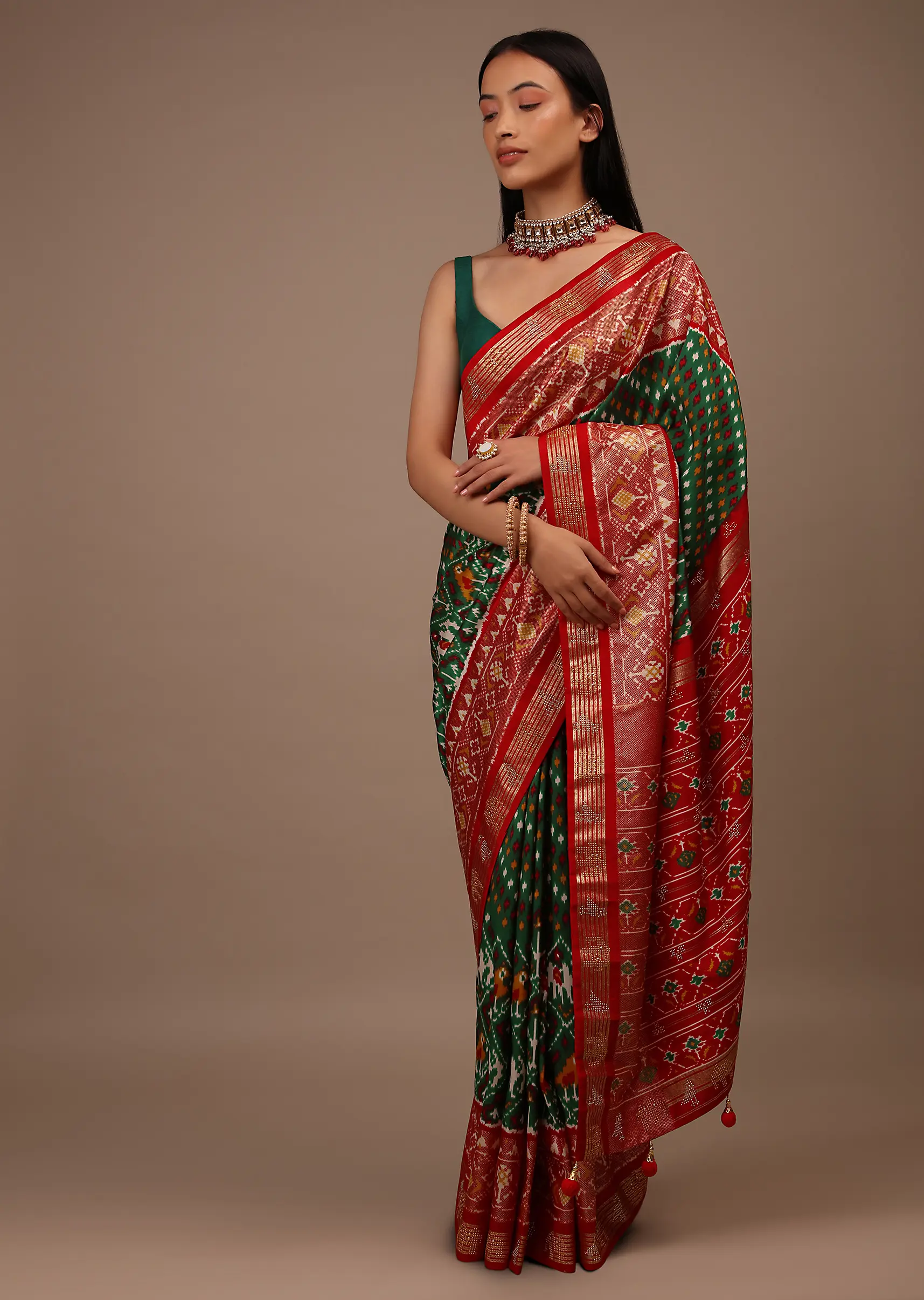 bottle_green_saree_in_silk_with_multi_colored_patola.webp