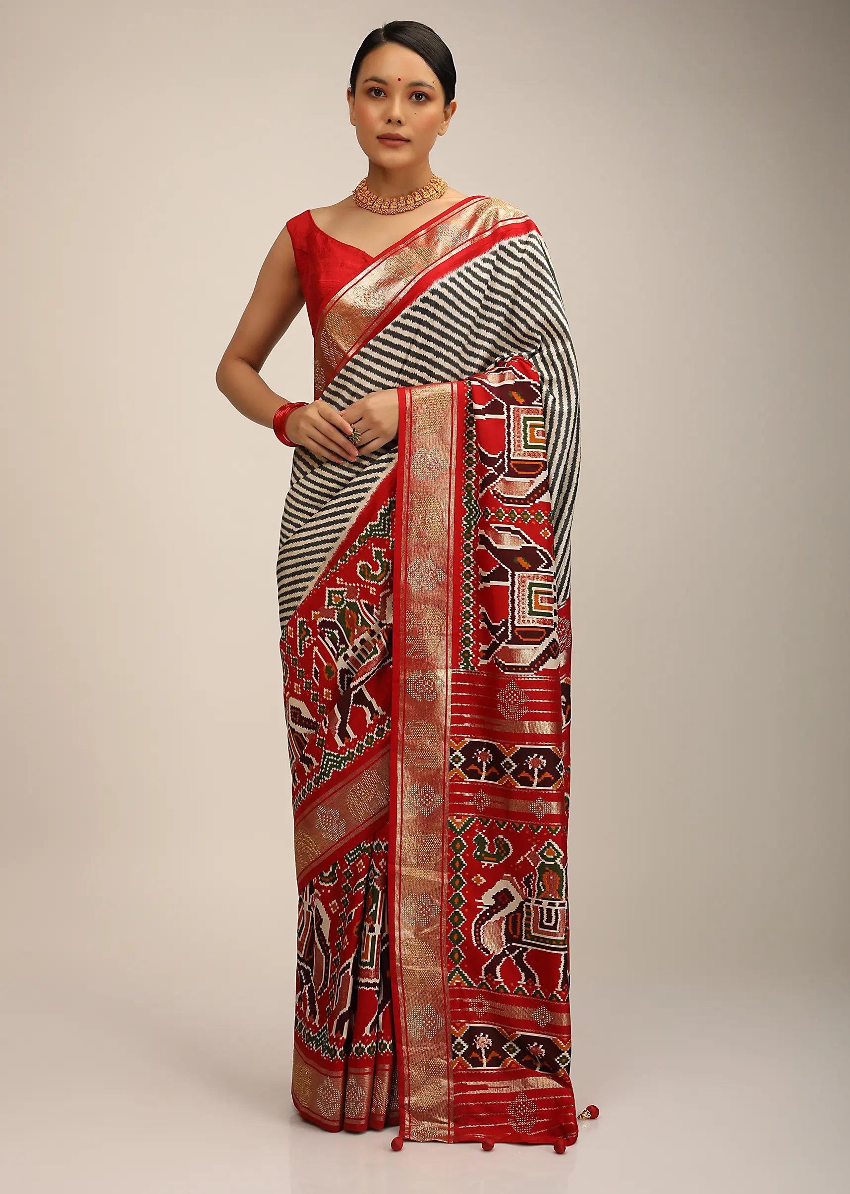 red_saree_in_silk_with_multi_colored_patola_print.webp